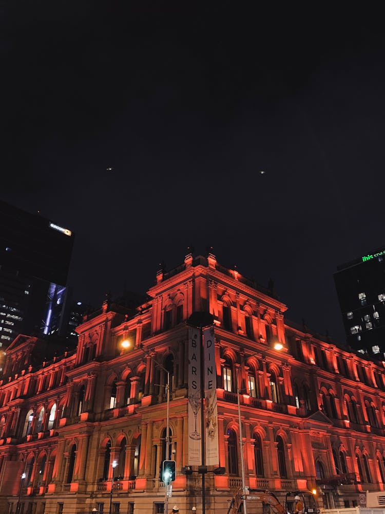 Illuminated In Red Townhouse By Night