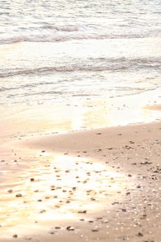 Peaceful beach scene with gentle waves and sunlit shore, perfect for serene and calming themes.