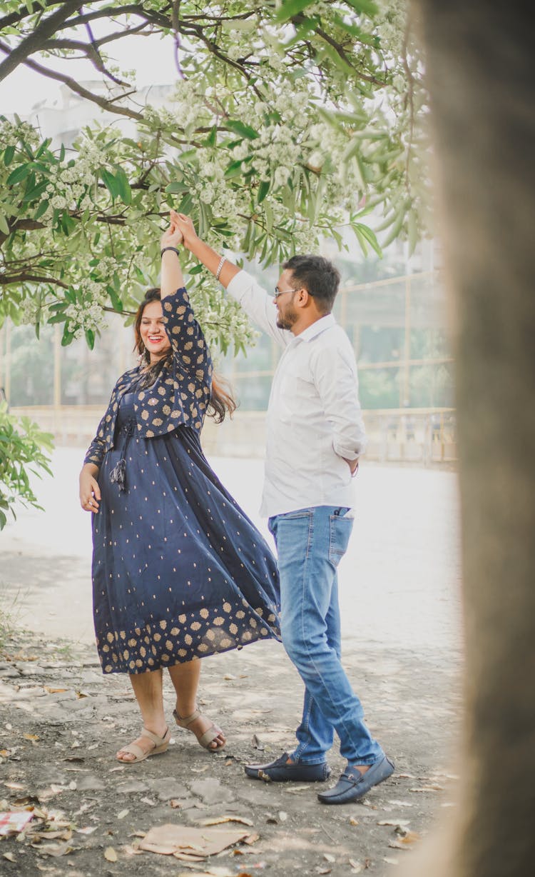 Happy Couple Dancing Under Tree