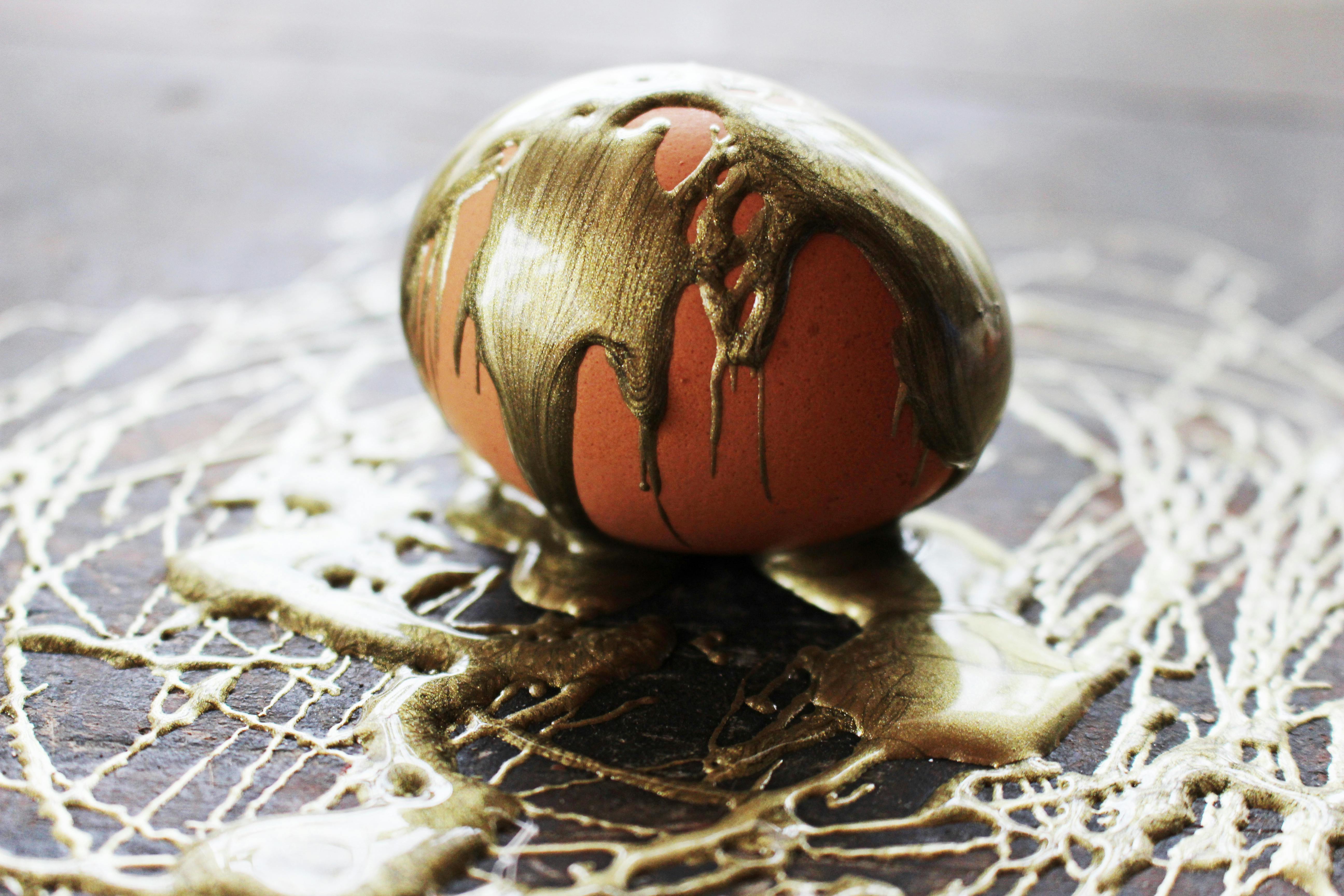 Close-up of an egg painted with gold, creating a unique artistic effect.
