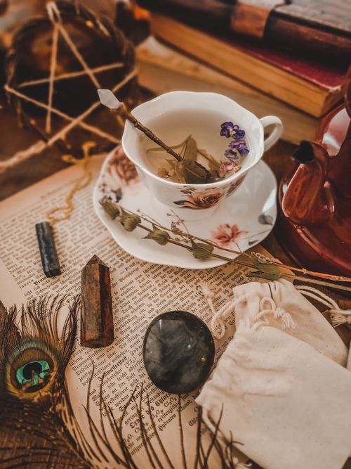 Free Enchanting still life of a tea set with a mystical theme, including books and stones. Stock Photo