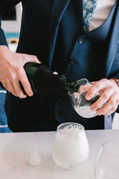 Person pouring champagne at a wedding reception in Siesta Key captures celebration and elegance.