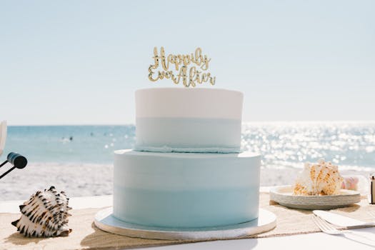 Beautiful beach wedding cake with seashells under a sunny sky, perfect for coastal weddings.