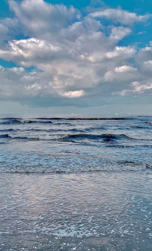 Free Calm waves and blue sky over the Mediterranean Sea at Port Said, Egypt. Stock Photo