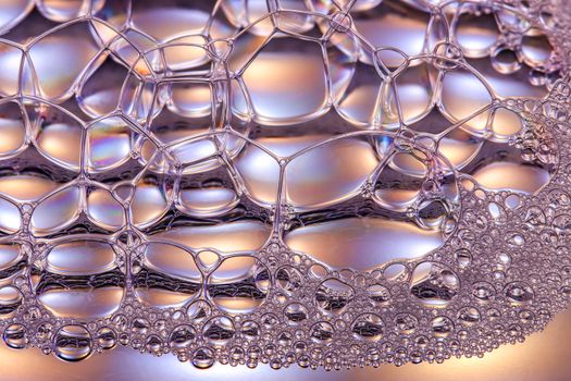 A microscopic view of a surfactant molecule breaking down grease to show how soap cleans.
