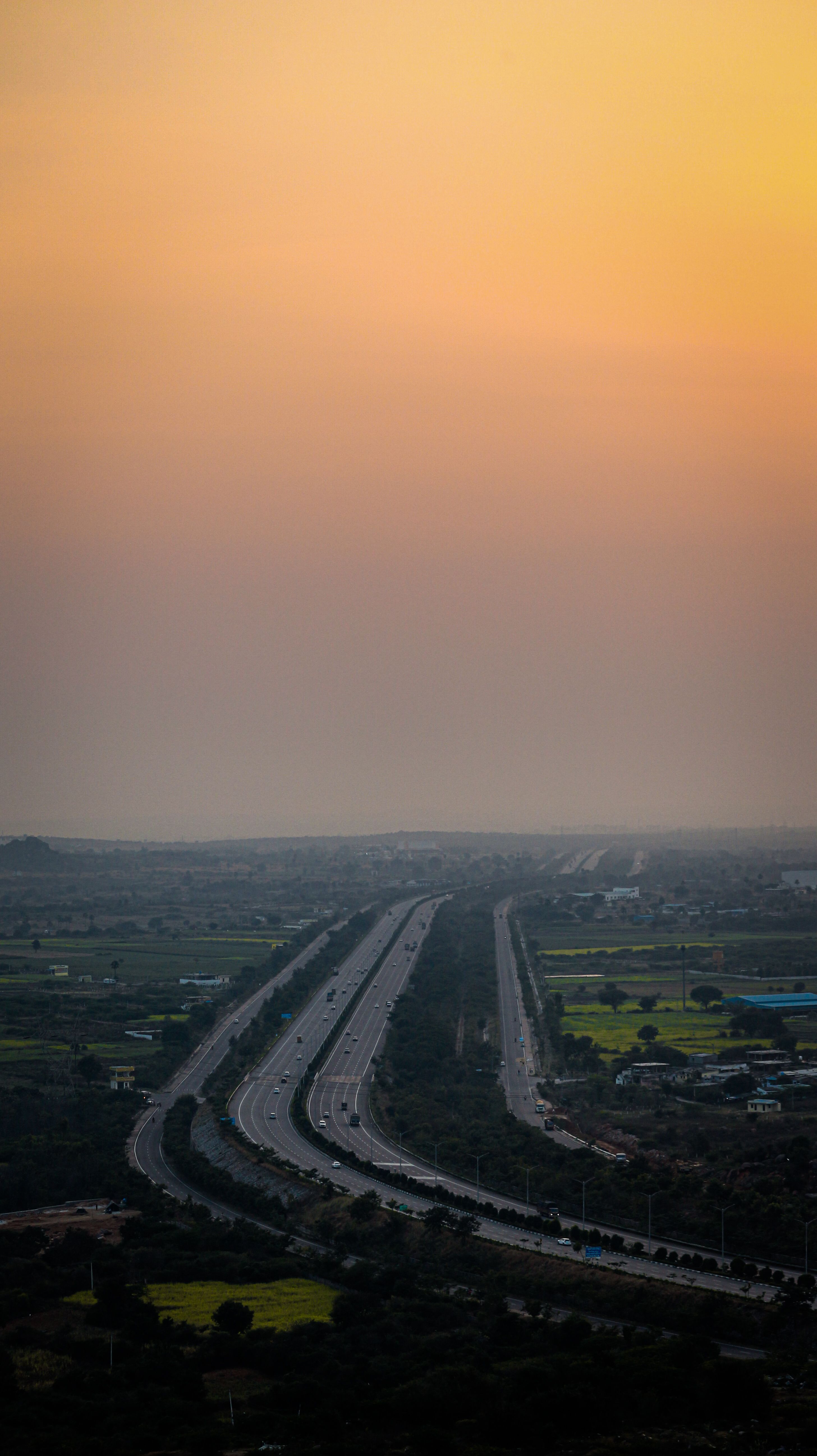 Discover the serene beauty of a sunset over a highway in Hyderabad, India.