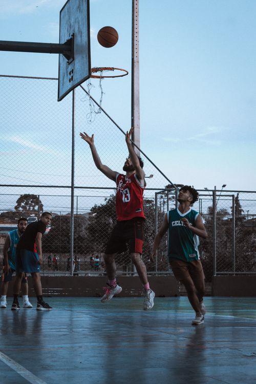 Free Engaging outdoor basketball match in Curitiba with players in action, capturing a spectacular shot. Stock Photo