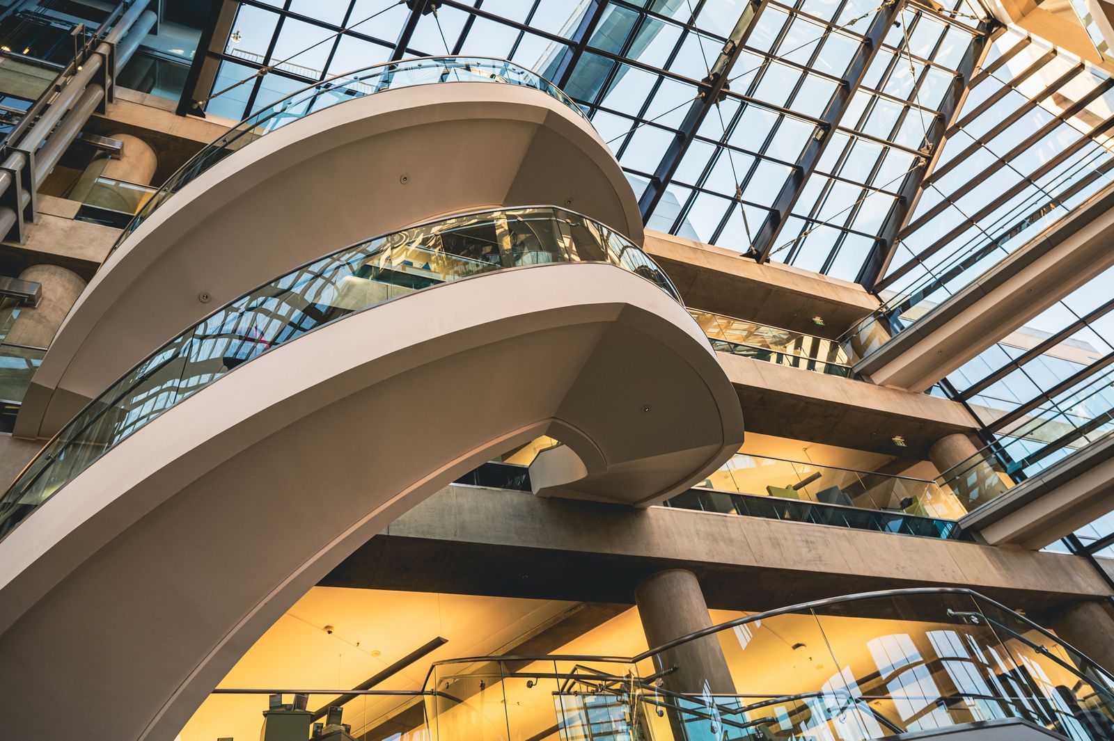 Curved staircases inside a bright modern research campus atrium — photo by Brett Sayles on Pexels