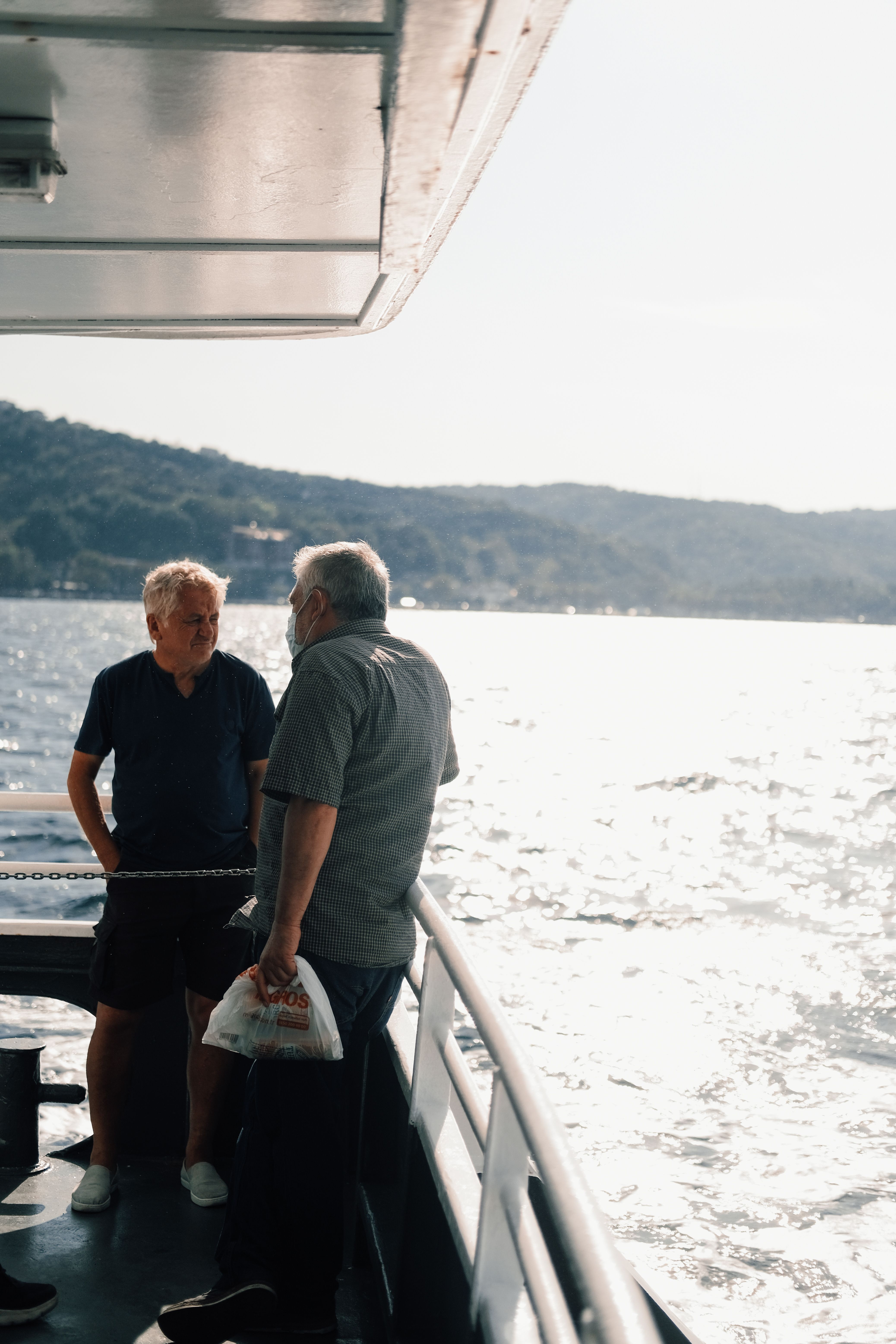 Gray Haired Men Leaning on Ship Railing · Free Stock Photo