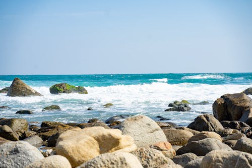 Low Angle Shot of Sea and Pebbles