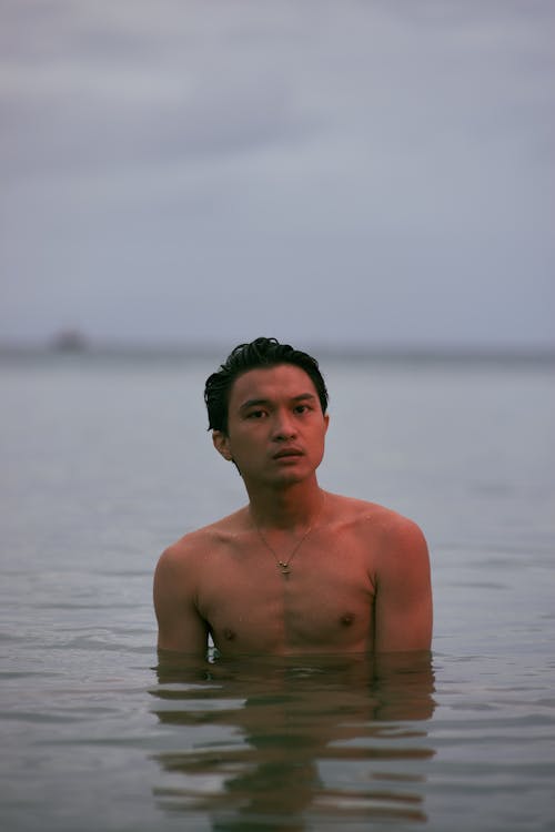 Shirtless Man in Water