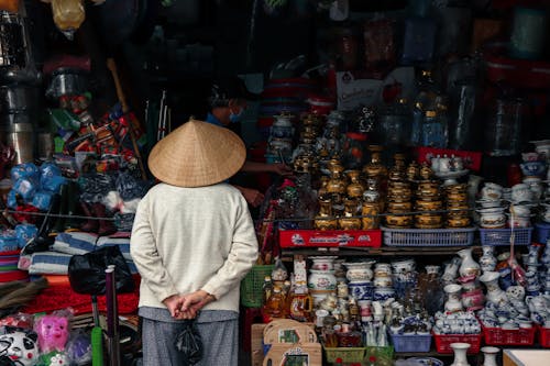 Chinese Person Looking at Craft Items at the Market Stall