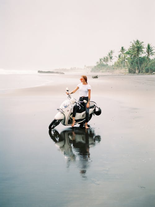 Woman on Scooter on Beach