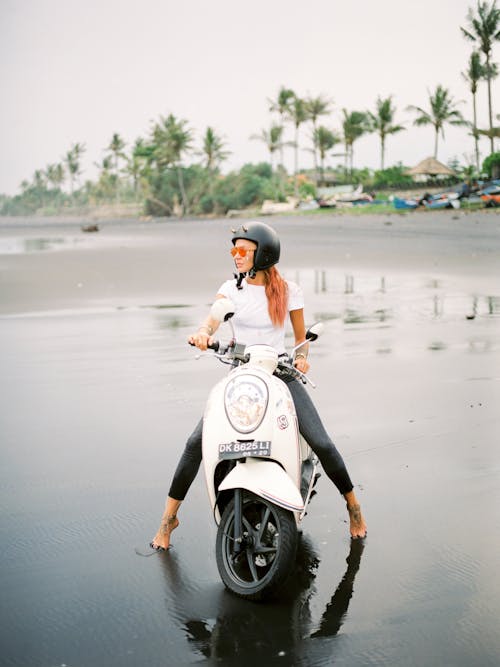 Woman on Scooter on Beach