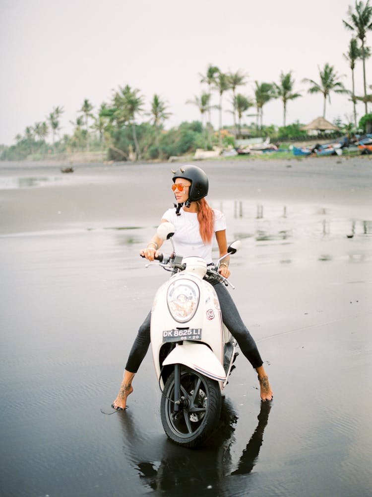 Woman On Scooter On Beach