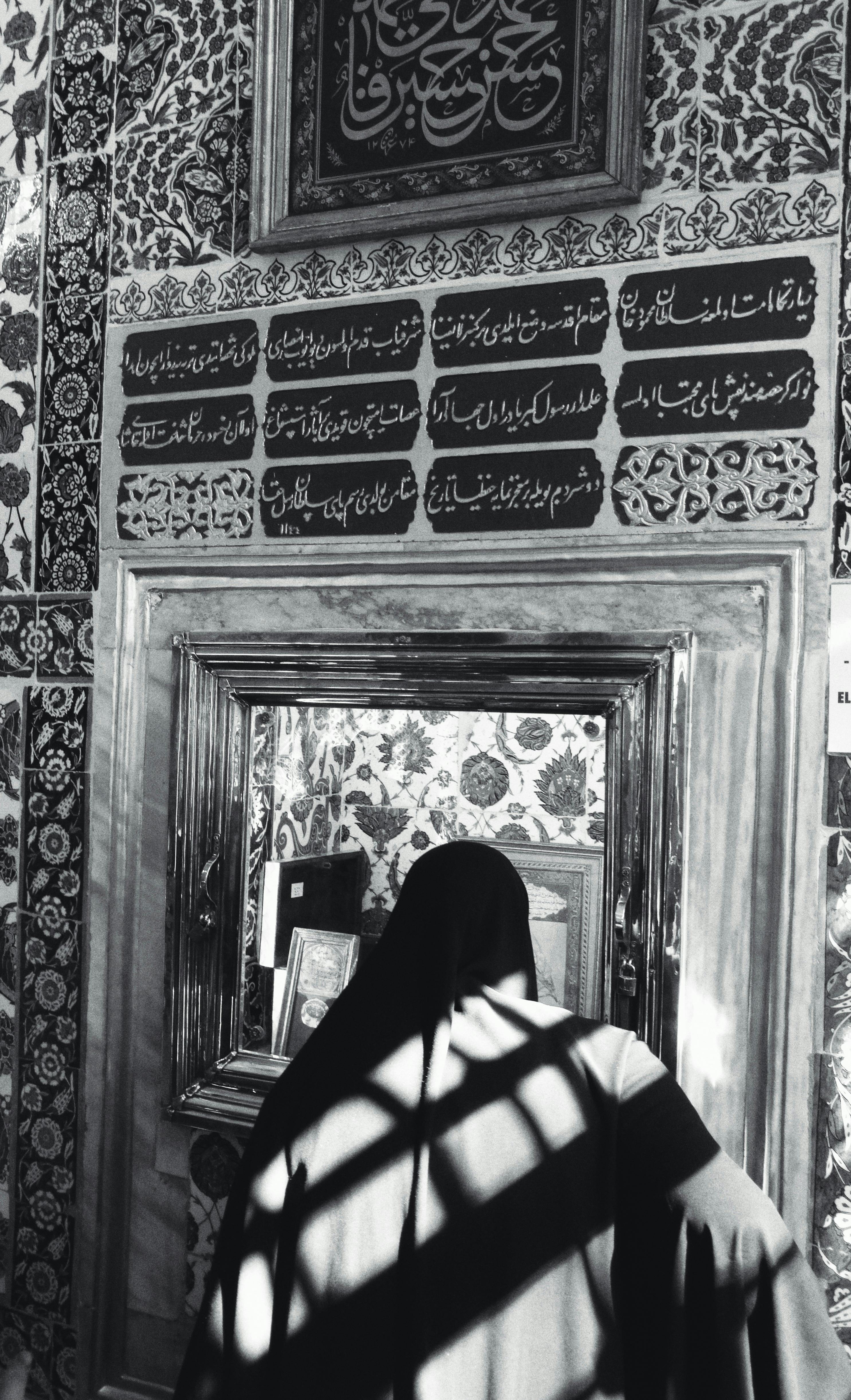 person standing near wall in mosque