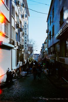 A bustling street scene in Istanbul featuring buildings and the Aydın Saray sign.