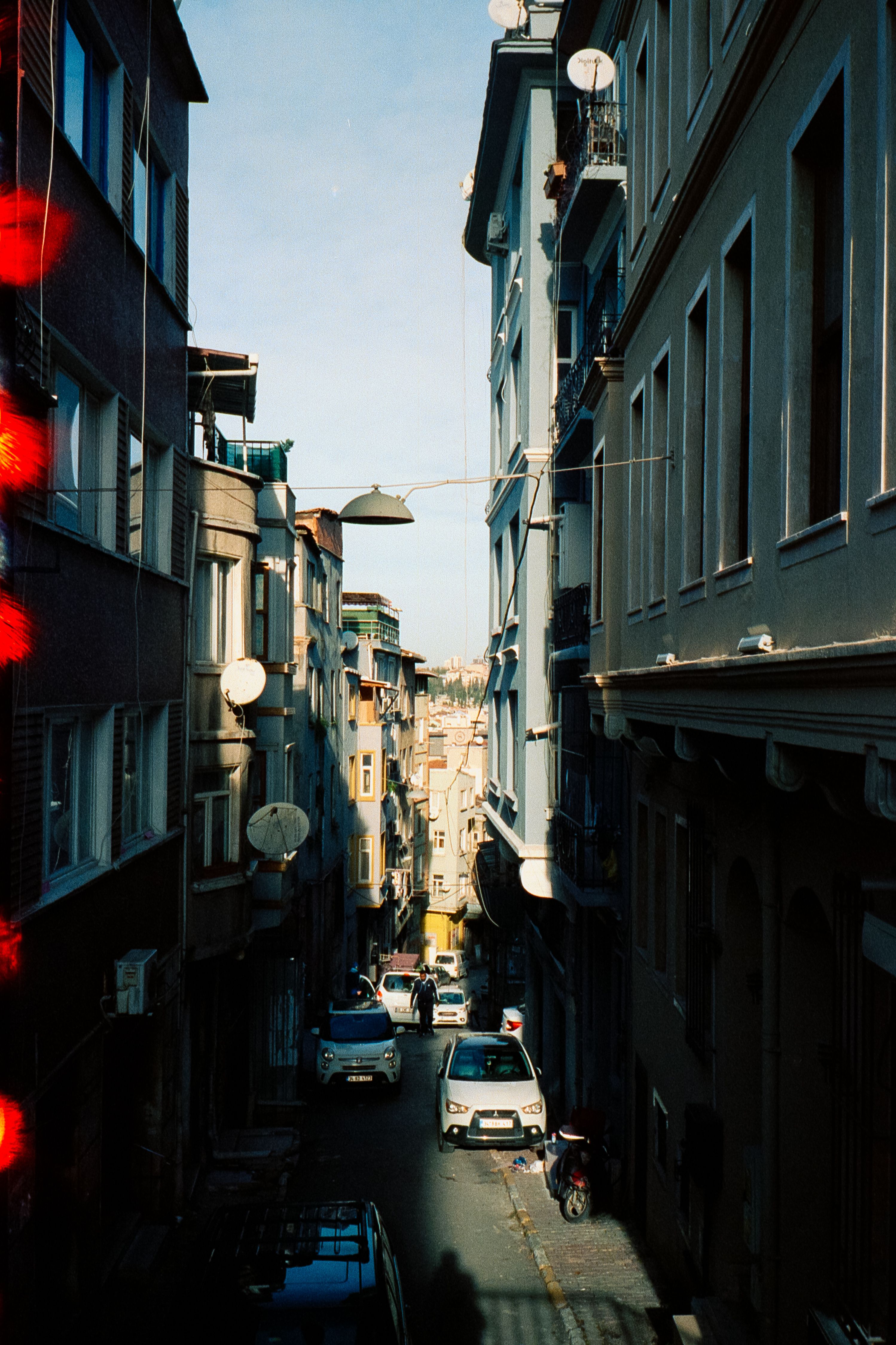 Cars Parked on Narrow Street Between Buildings · Free Stock Photo
