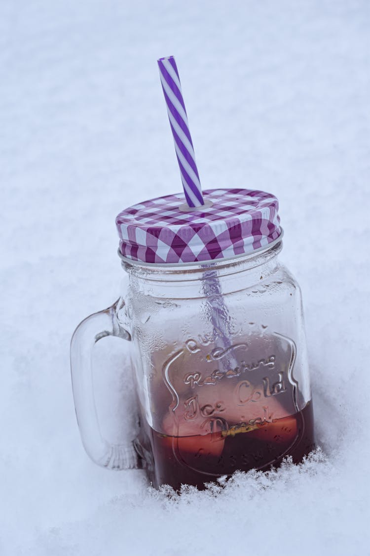 Juice In Jar With Straw In Snow