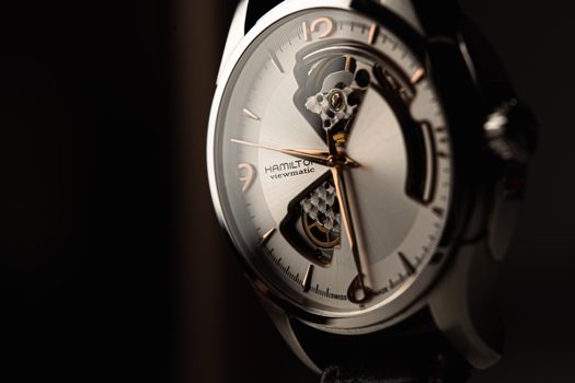 A detailed close-up of a luxury wristwatch showcasing sophisticated craftsmanship and mechanical design.