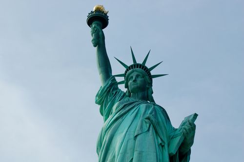 Free A close-up of the Statue of Liberty in New York City against a blue sky. Stock Photo