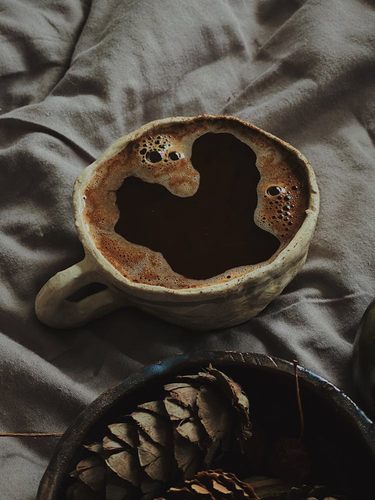 Ceramic Mug With Brown Bubbly Liquid