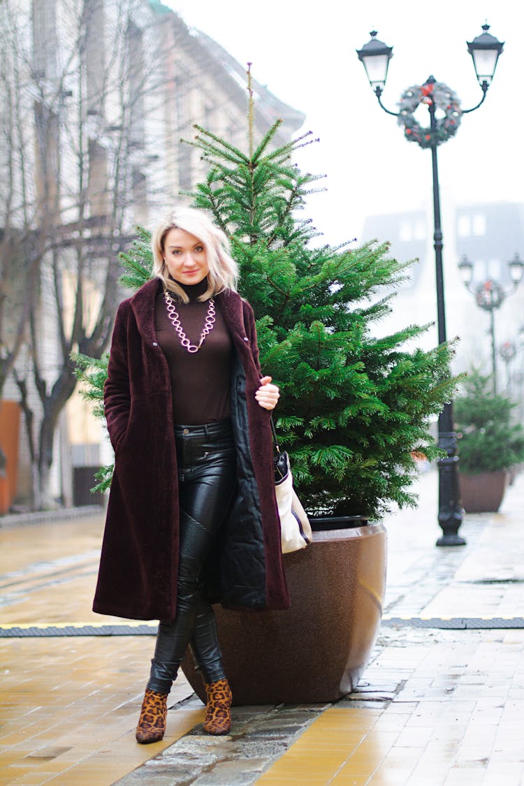 
A Woman Wearing A Velvet Coat And Leather Pants