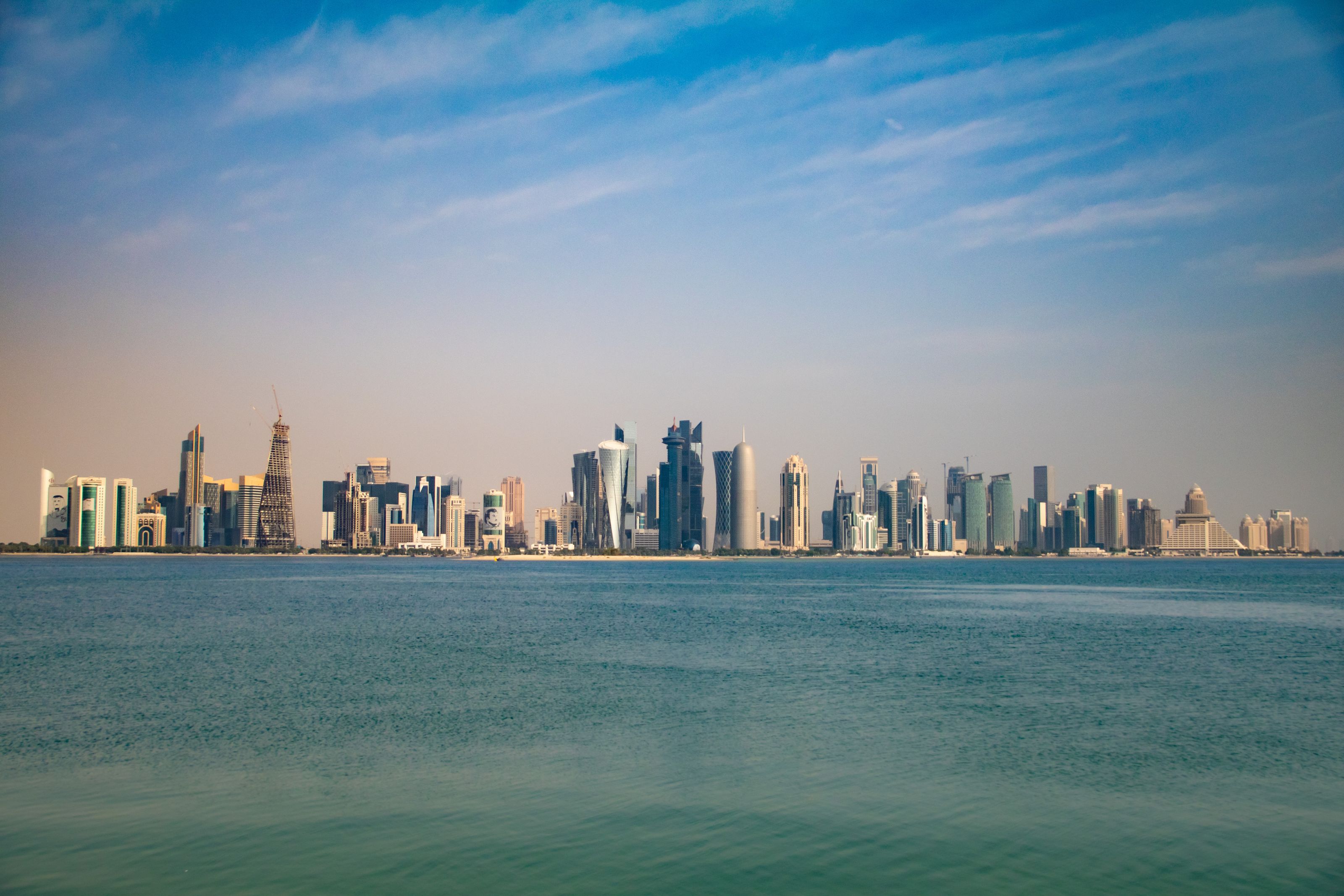 Captivating view of Doha skyline from the Corniche, featuring modern architecture under a clear blue sky.