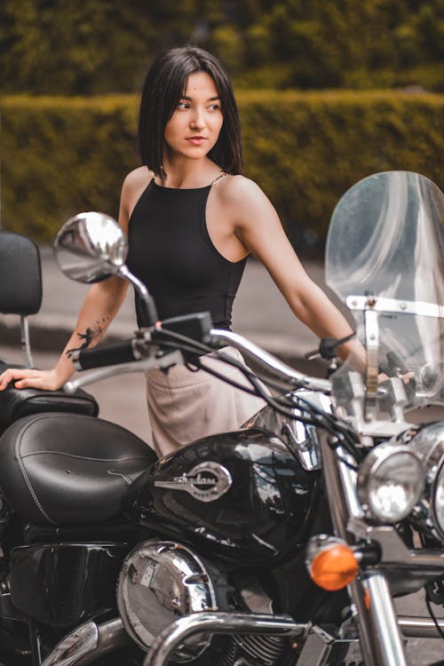 Free Woman Standing next to Motorcycle  Stock Photo