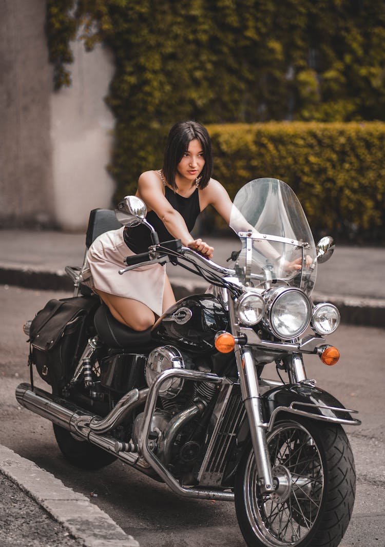 Woman Posing On Expensive Black Motorcycle