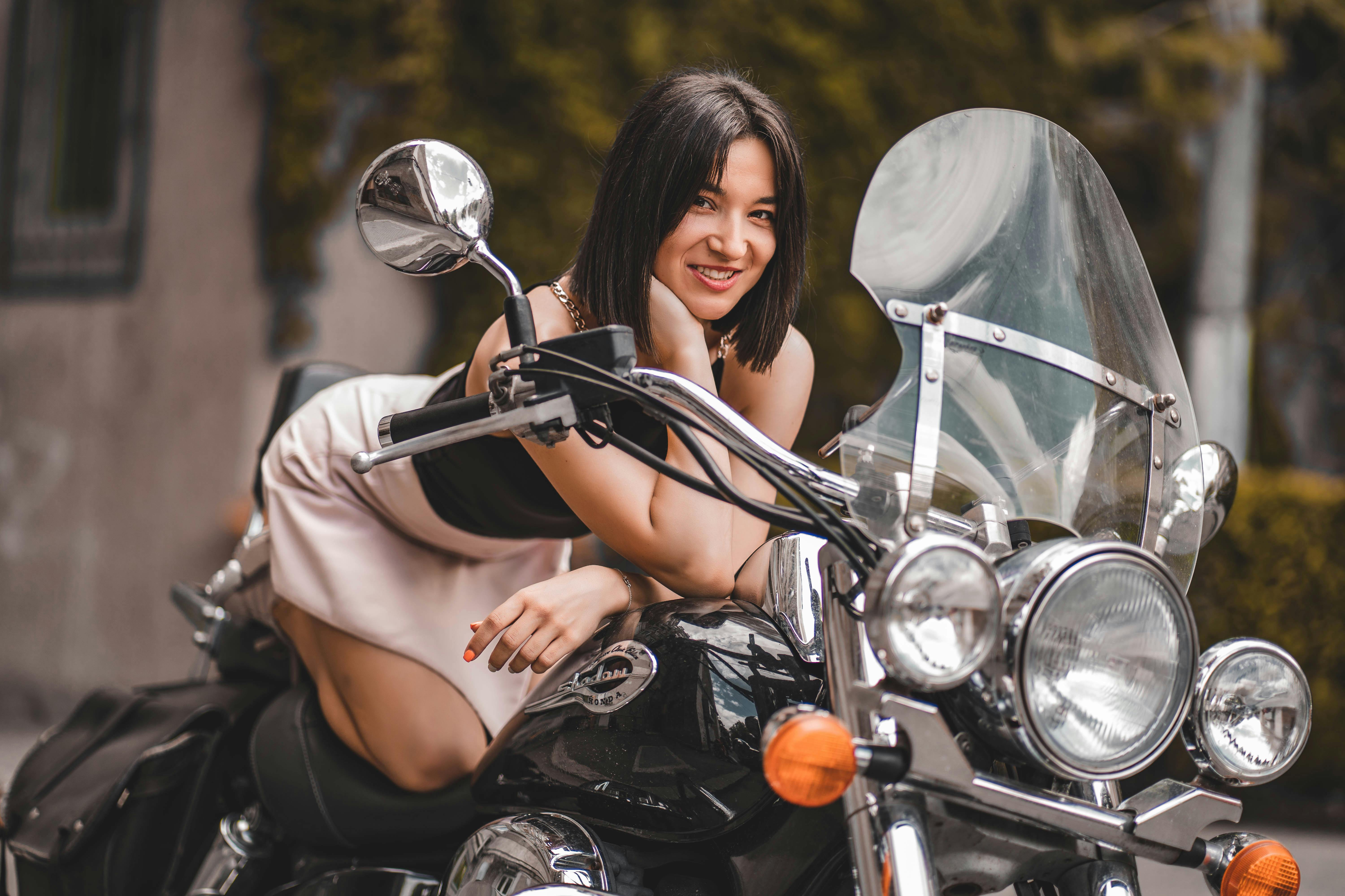 Woman Kneeling on a Motorcycle · Free Stock Photo