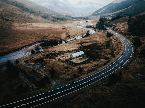 Aerial View of a Highway Road Between Mountain Ranges