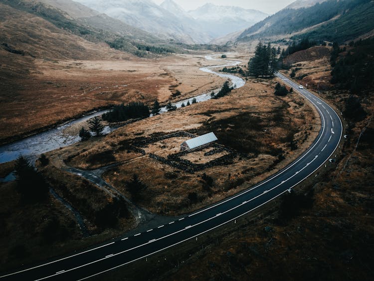 Aerial View Of A Highway Road Between Mountain Ranges