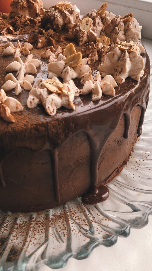 Free Close-up of a chocolate cake with whipped cream and nuts, perfect for dessert lovers. Stock Photo