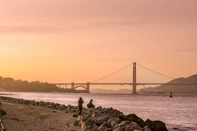 Tourists Looking At The Golden Gate Bridge In San Francisco