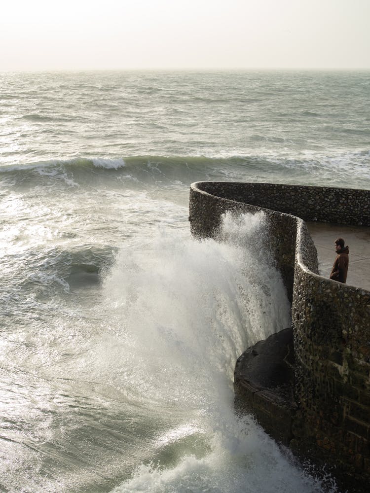 Ocean Waves Crashing On Brown Concrete Wall