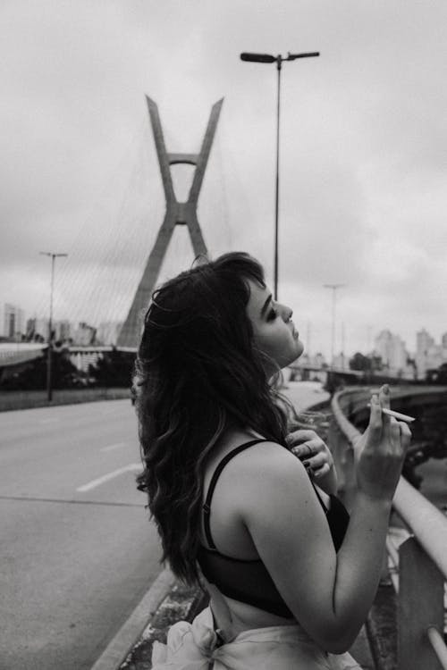 Monochrome Photo of Woman Smoking a Cigarette