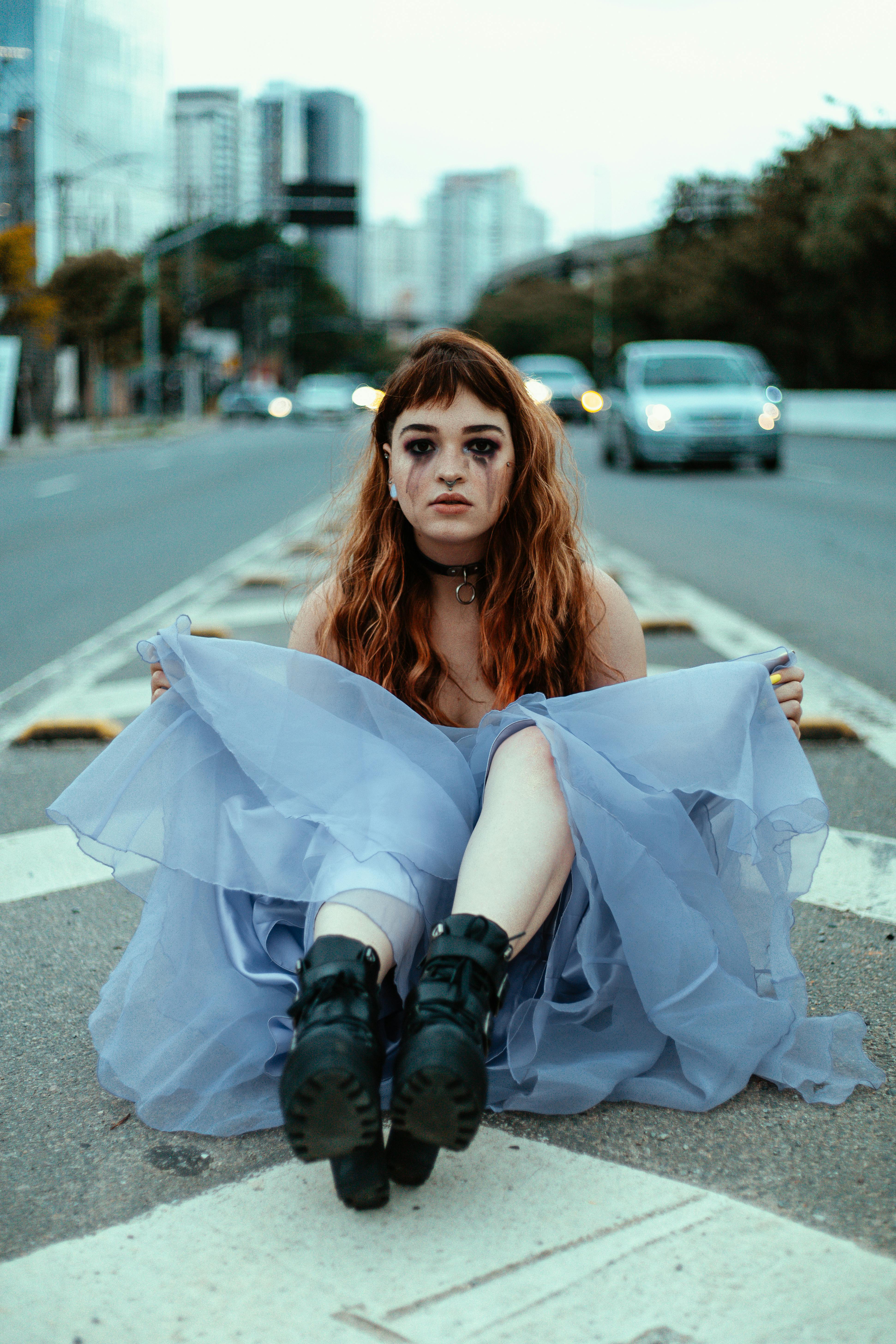 crying girl sitting on road