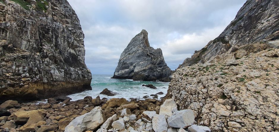 Explore the impressive rocky coastline of Colares, Lisbon, showcasing towering cliffs and tranquil sea views.