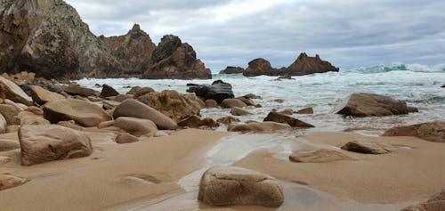 Free Brown Rock Formations on Beach Shore Stock Photo
