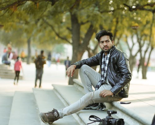 Bearded Man in Black Leather Jacket Sitting on Concrete Stairs 