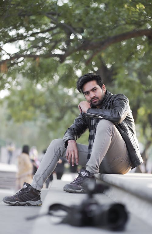 Man in Black Leather Jacket Posing on Concrete Stairs 