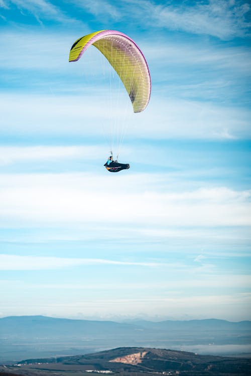 Free Person Paragliding in the Sky Stock Photo