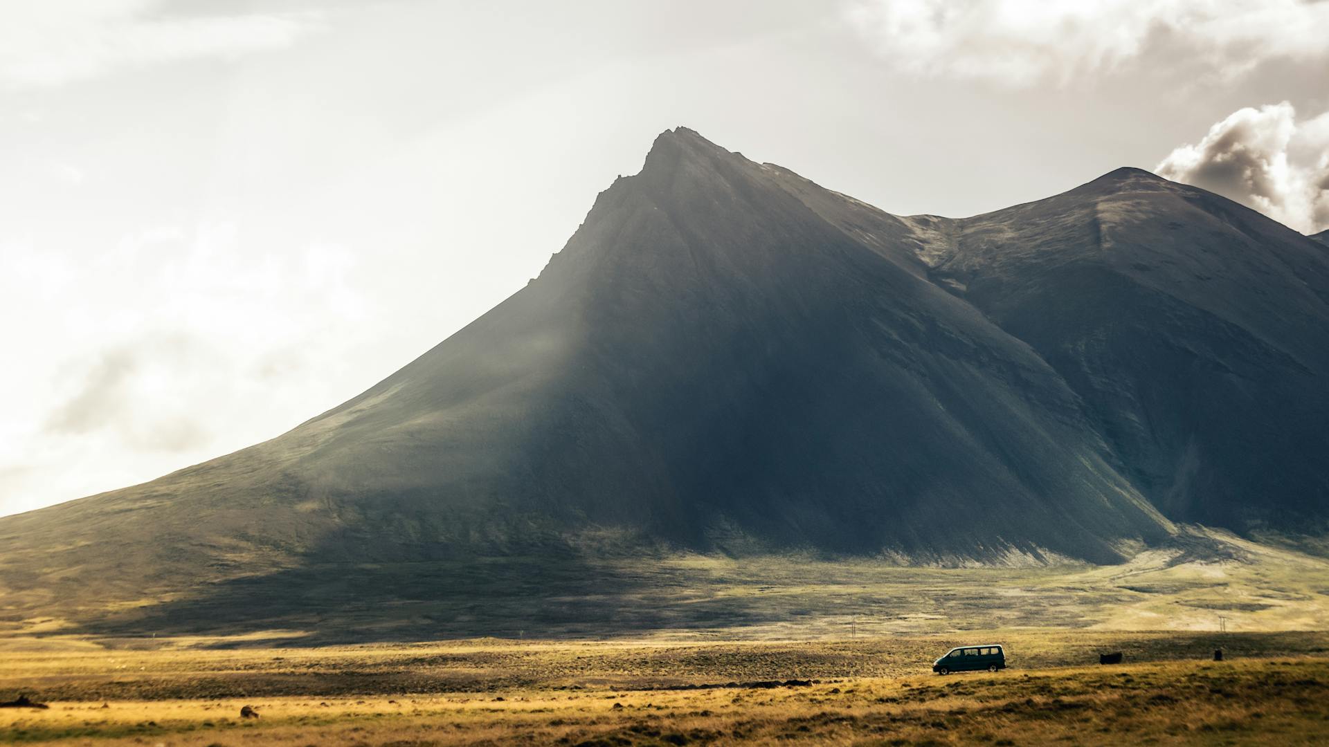 A Van Travelling on a Road Near the Mountain