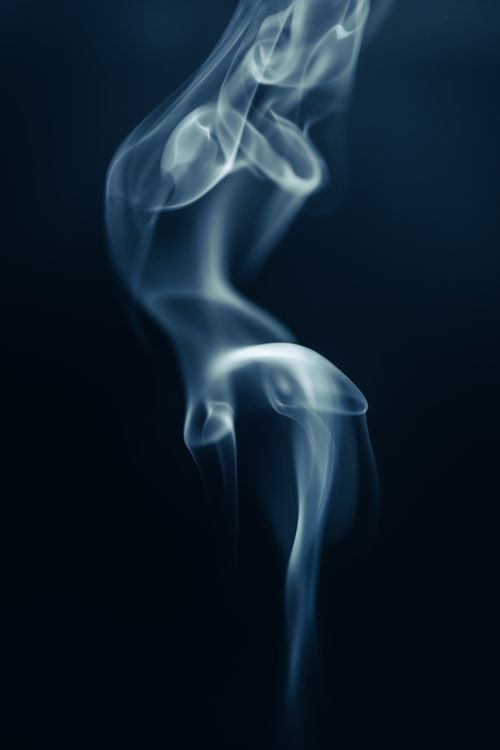 Free Artistic close-up of swirling smoke against a dark backdrop, creating a mysterious and abstract visual. Stock Photo