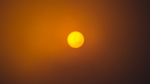 Free A Yellow Sun in the Sky during Sunset Stock Photo