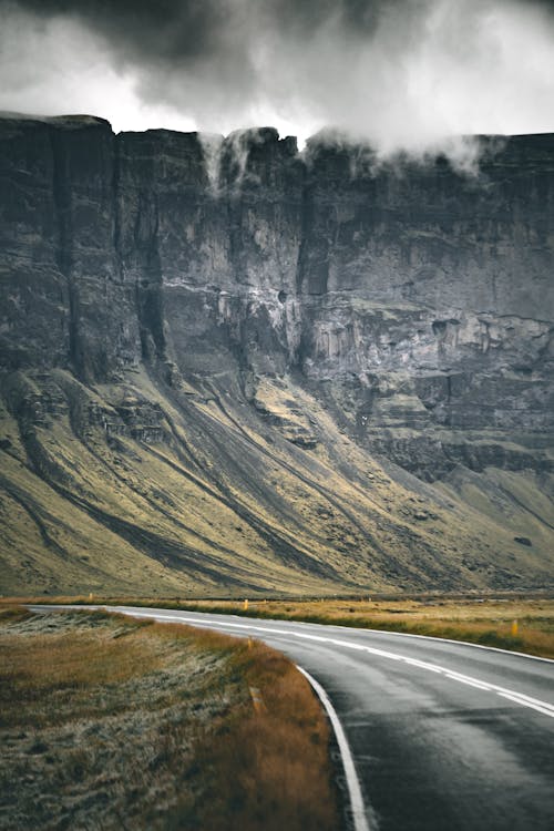 Free Gray Asphalt Road Near Gray Rocky Mountain Stock Photo