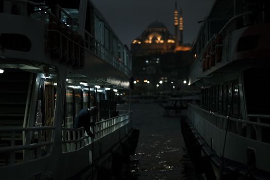 Man on a Boat with the Suleymaniye Mosque in the Background, Istanbul, Turkey