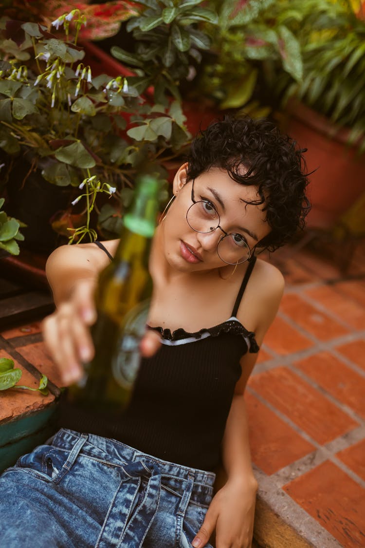 Woman Making A Toast With A Beer Bottle