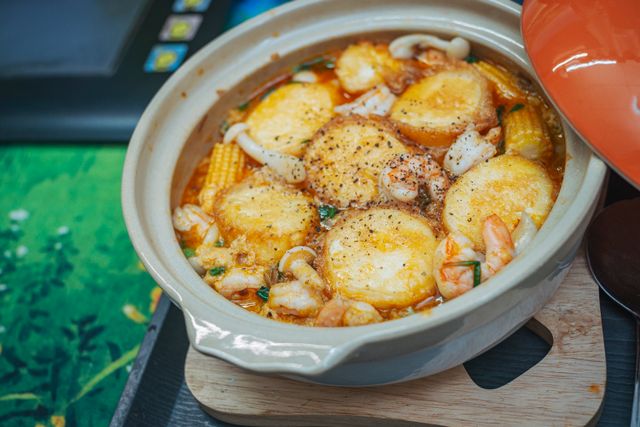 Delicious seafood and tofu hot pot packed with mushrooms, corn, and shrimp in a flavorful broth.